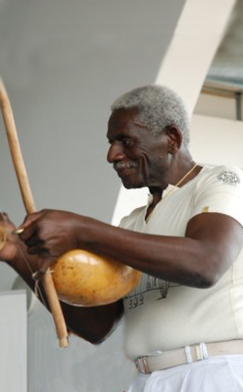 Mestre Sombra playing berimbau, photo by courtesy of Capoeira Canigo
